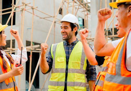 Construction workers in hard hats and hi-vis vests on a jobsite